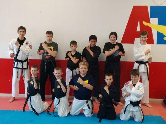 Black belts posing after two new black belts ceremony.