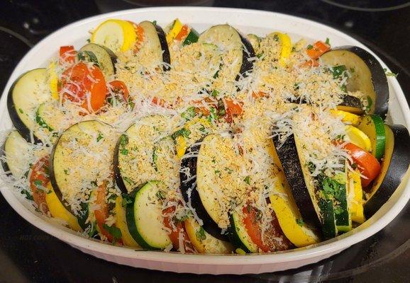 Slight twist on ratatouille.  Egg plant, yellow squash,  zucchini and roma tomatoes.  Light dusting of panko, parsley and fresh Parmesan.