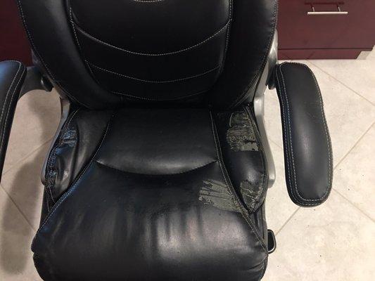 Moving company applying duct tape directly onto leather chair