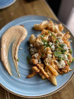 Swank Farm Cauliflower- Buffalo sauce flavored cauliflower with cheese and green onion