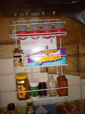 Spice rack from Container Store hangs from my range hood with magnetic hooks from Harbor Freight .