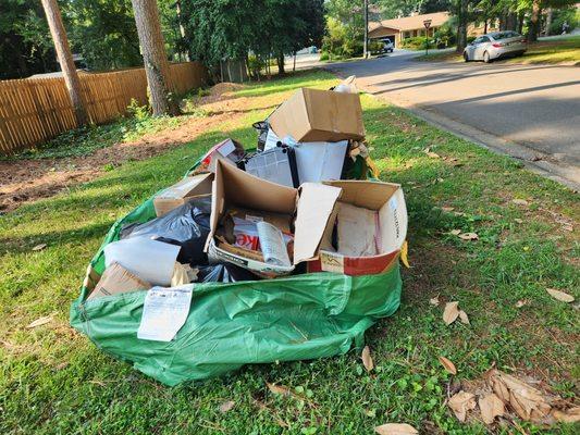 Old boxes and trash ready for curbside pickup.