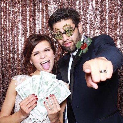 Happy bride & groom. Having fun in the photo booth.