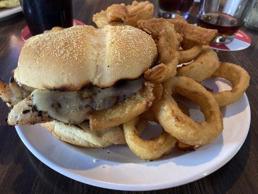 Grilled chicken sandwich with Swiss cheese and onion rings