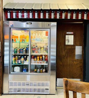 Cold beverages, entrance to the kitchen, Chilean flags over them