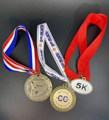 Not only do we carry medals, we can engrave race times on your medals.