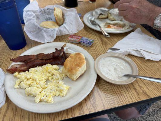 Two egg breakfast with bacon and biscuits.