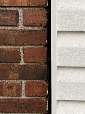 Brick separating from garage door framing!