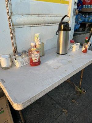 Condiments table with coffee