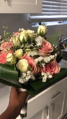 A bridal bouquet with weird leaves on the side.