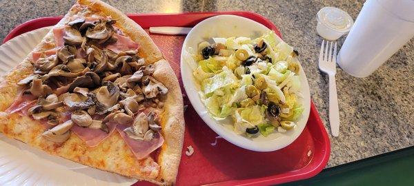 Pizza slices with ham and mushrooms. Dinner salad with Italian dressing.