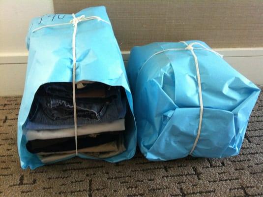 Neatly folded blue packages from their laundry service.