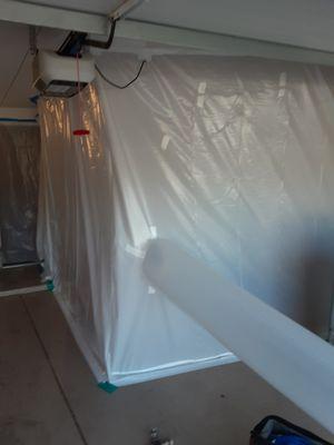 containment built in garage extending into homeowners' rear door (mold)