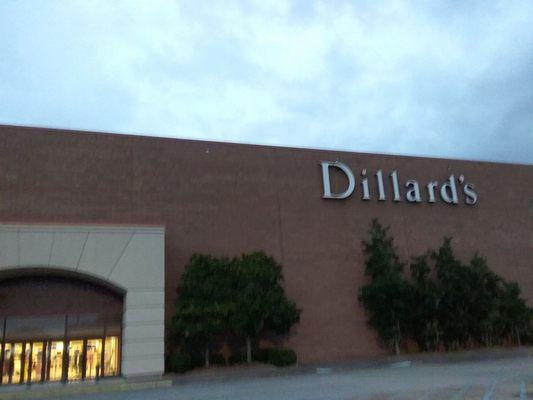 Parking lot of Dillard 's. About to rain but sign was still lit and visible.