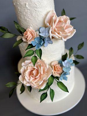 Stucco buttercream wedding cake with handmade sugar flowers