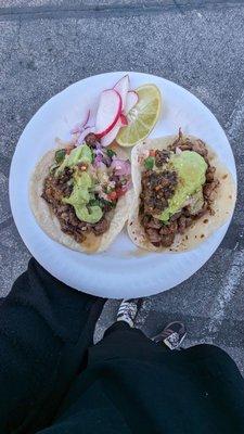 Freshly made handmade tortillas (tortillas hecho a mano). Asada (marinated beef) on a flour tortilla and cabeza taco on a  corn tortilla.