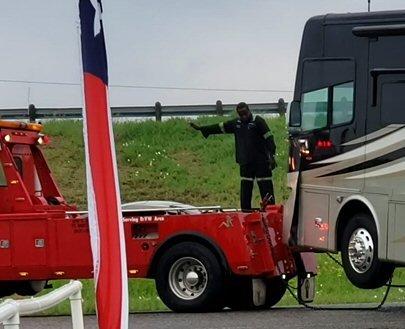 Corner of motorhome, guy standing on bed of truck was trying to guide the driver. Would NOT recommend these people!