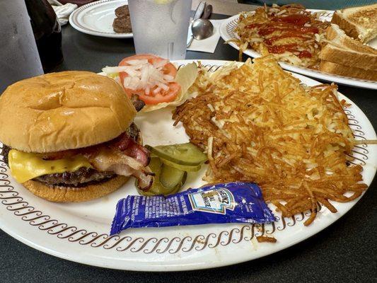 Bacon cheese burger with all the fixings and hash browns