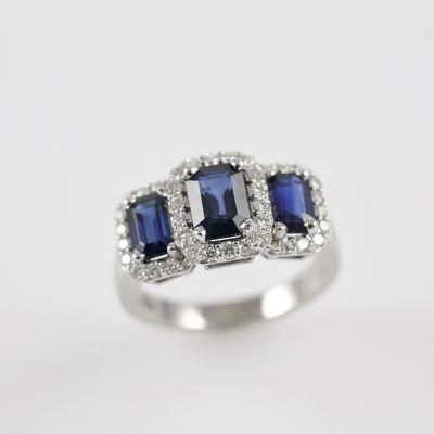 Three stone Blue Sapphire Ring with diamond halos.