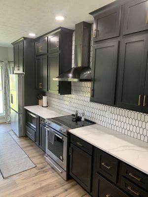 Haas Cabinetry in Black with custom tile backsplash and quartz countertops