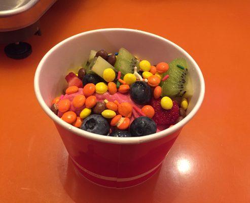 Strawberry Frozen Yogurt with Kiwi, Blueberries, Reese's pieces, and sprinkles.