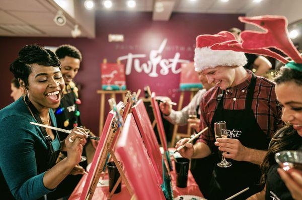 Painting and drinking is a fun office holiday party idea, too!