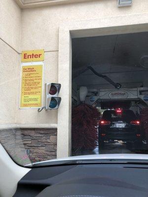 You must wait to pay for car wash until the car infront of you is done.