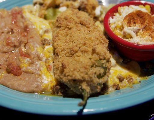 ground beef chili relleno with refried beans and street corn