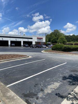 View of the parking lot and bays. The only practical spot would be to move the air machine to the side of the building where the SUV is