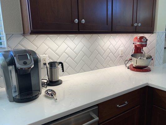 Misterio quartz paired with a herringbone tile that we bought from Lowe's. My husband did the tiling.