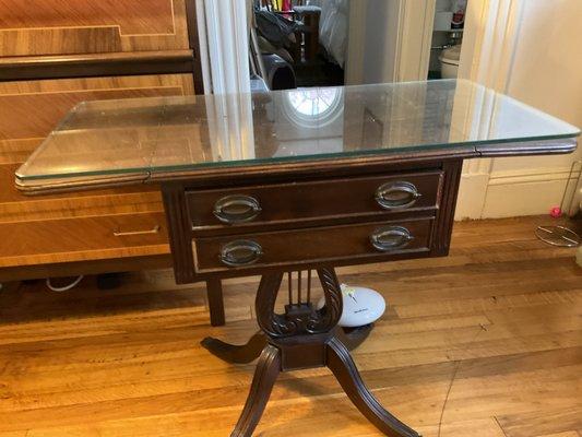 Set of 2 side tables with glass tops. 2drawers. Side leaves can be lowered. Top surfaces need refinishing.