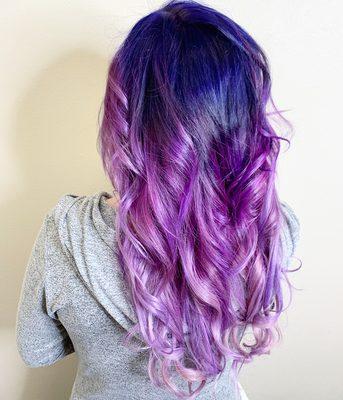 Long softly curled hair, colored in ombré style from dark blue to purple to pink. By Stacey Kirkham