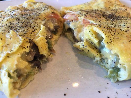 Veggie Omelette deliciously filled w/ sautéed goodies.