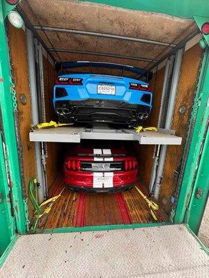 My fiancés car (red) and my baby (blue) loaded up in the trailer ready for safe travels.