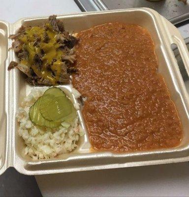 Chopped BBQ meat with mustard sauce, hash over rice and slaw. Yum!