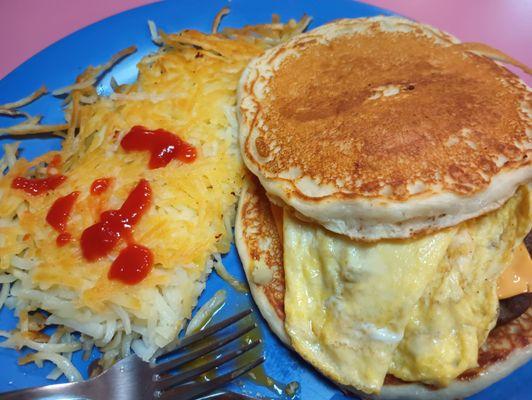 Dunkin Griddle (scrambled eggs, sausage, and cheese between 2 pancakes) breakfast special plus Hash Browns