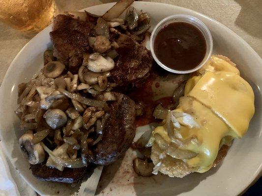 Tenderloin with onions and mushrooms and cheesy hashbrowns on the side.