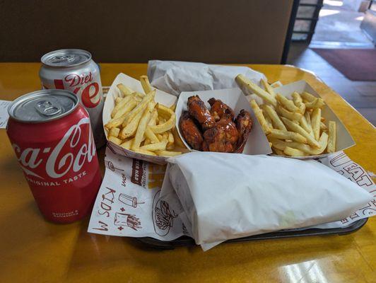 Fries, turkey bacon sandwich and buffalo wings