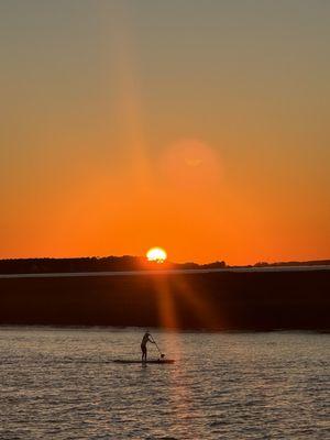 Cool shot of a paddle boarder with the sunset in the background