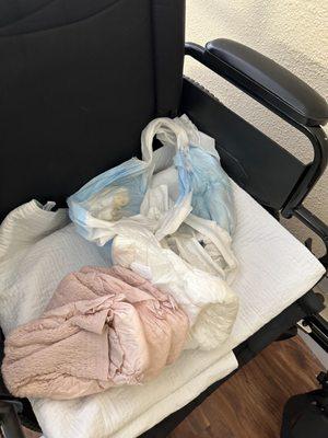 A second picture of the soiled diaper in the wheelchair