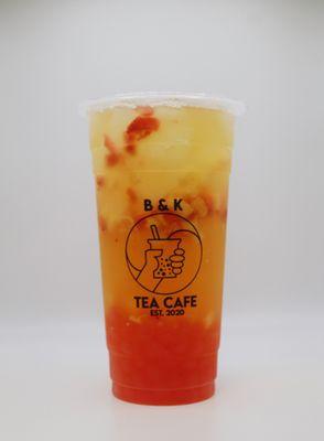 Peachy Lychee Fruit Tea with fresh cut fruit and strawberry poppers