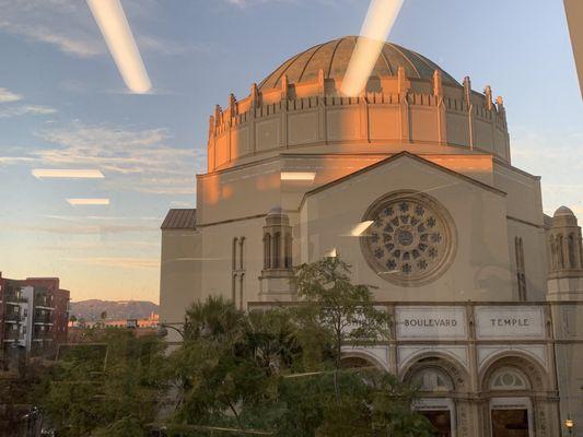 The Wilshire Boulevard Temple with the Hollywood sign visible in the hills on the left in early evening light. One of the best views in LA.