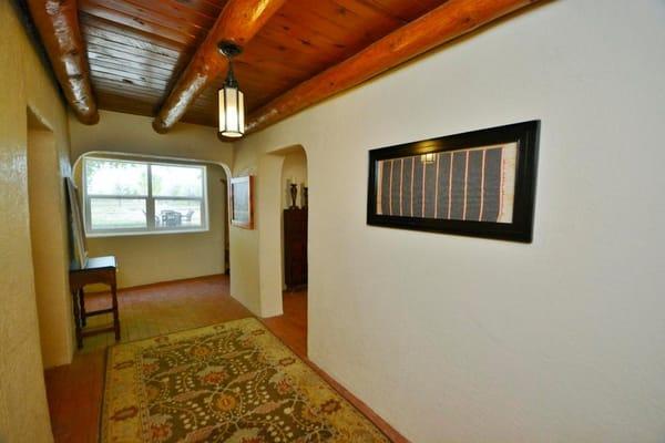 Entryway brick, plaster walls, and new opening work.