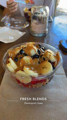 Açaí bowl, strawberries, blueberries, bananas, peanut butter drizzle, and honey drizzle. (Comes with granola)