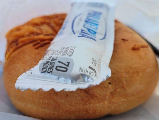 Warmed up Asiago bagel and cream cheese