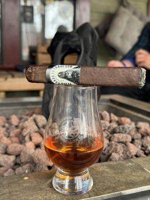 Whiskey and cigar at the fire pit