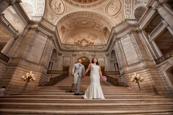 A bride and groom at San Francisco City Hall enjoying their wedding photography.