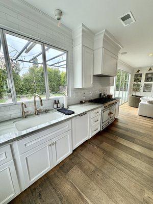 Custom kitchen cabinets with shaker style doors, a molding trim, and custom panel for dishwasher to blend kitchen scheme.