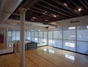 Group fitness studio with translucent windows to let light in but maintain privacy.