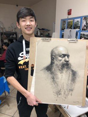 Kevin (13), with his charcoal portrait drawing